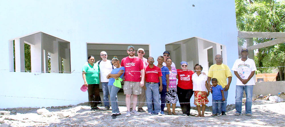 The St. Anne's missioners with members of the Las Carreras community in front of the church building under construction.